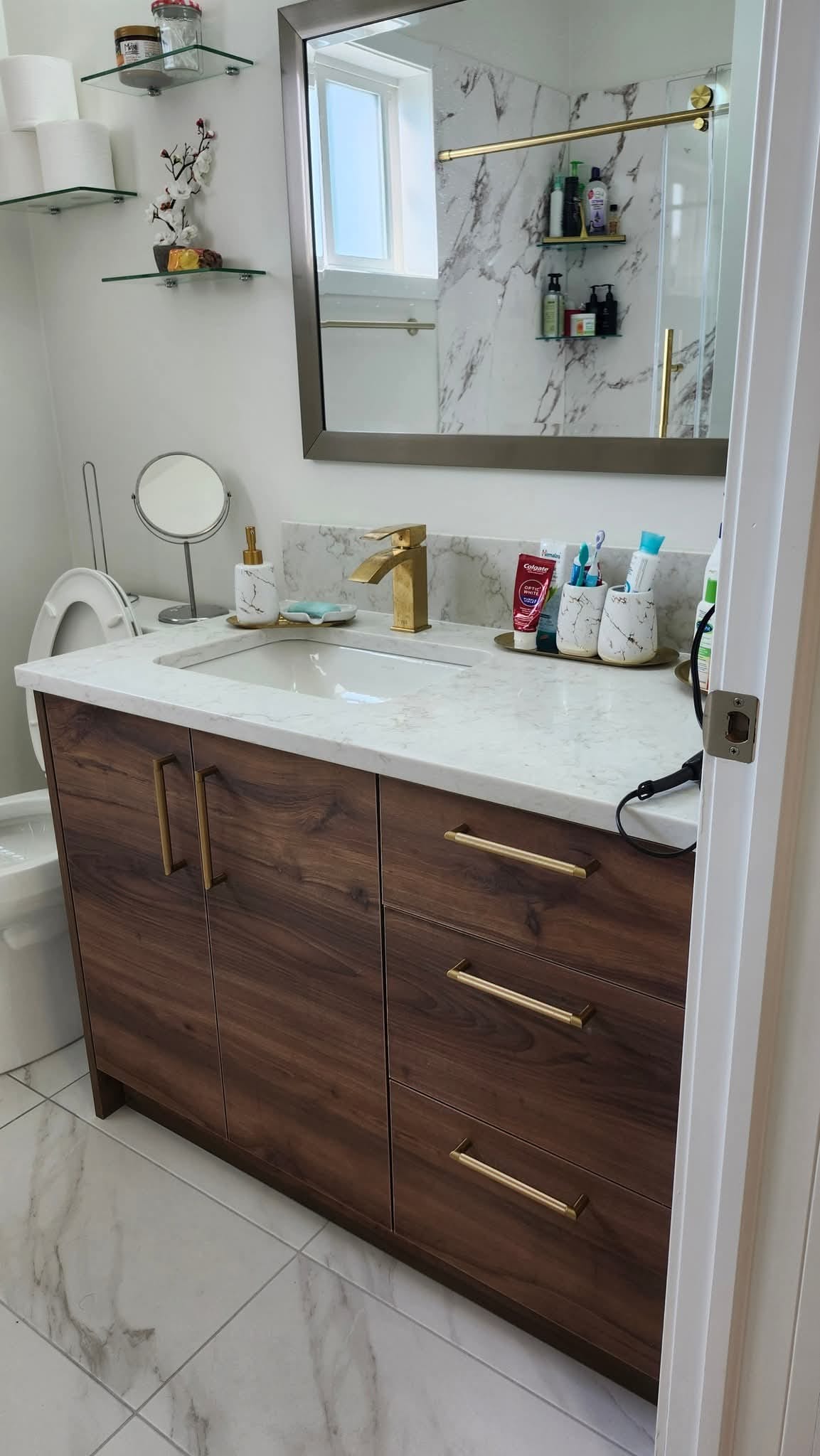 Custom bathroom vanity with walnut finish and marble countertop — Winnipeg Renovation