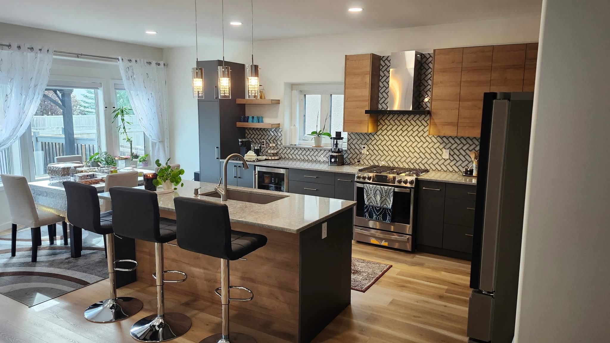Modern kitchen renovation in Winnipeg — dark cabinets with wood accents