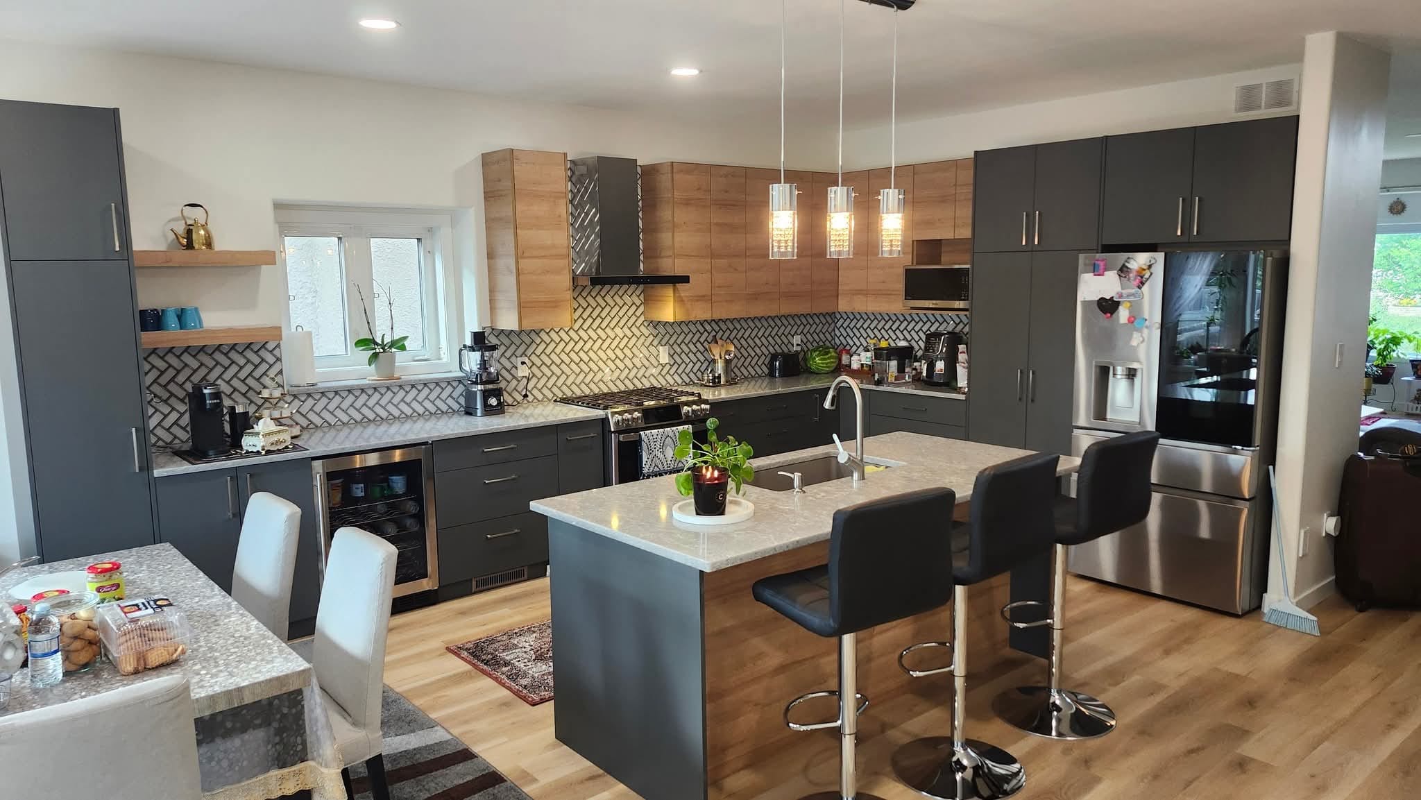 Kitchen renovation with island and pendant lighting — Winnipeg Renovation